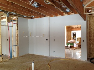 Drywall installed along the kitchen/garage wall