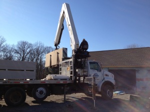 Crane picking up the drywall