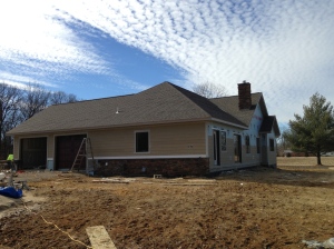 View of the back and garage side with siding